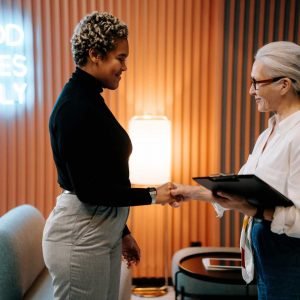 two women shaking hands